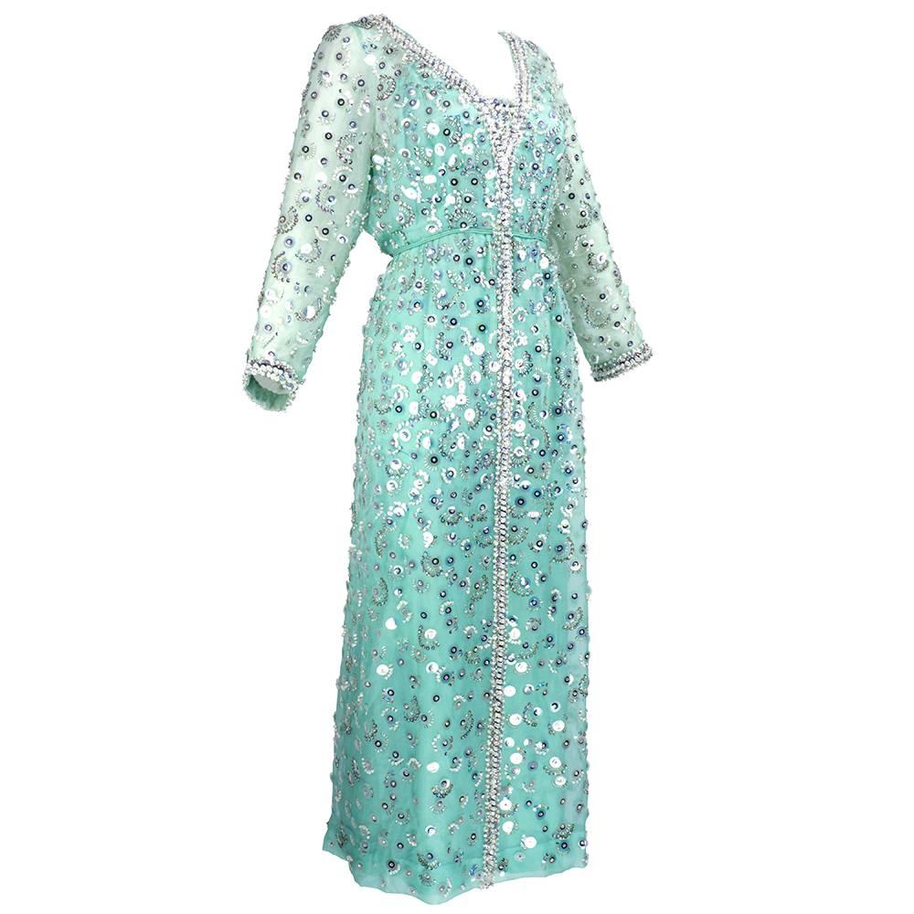 Super 60s high style gown in great shade of sea foam green organza. Heavily embellished with silver and iridescent sequins, beads and faux gems. Empire waist. Fully lined with 3/4 sleeves.