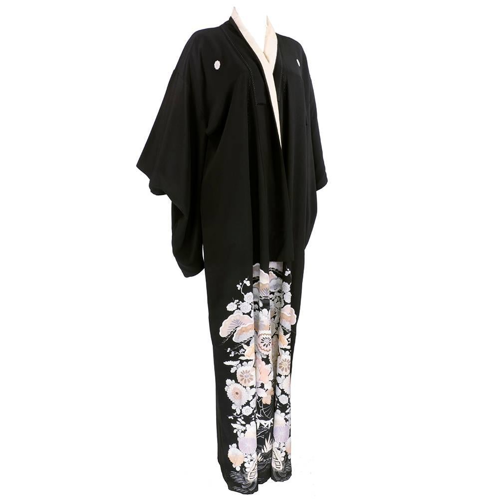 Stunning kimono in black silk. Floral print on lower front into interior . Long dropped sleeves.