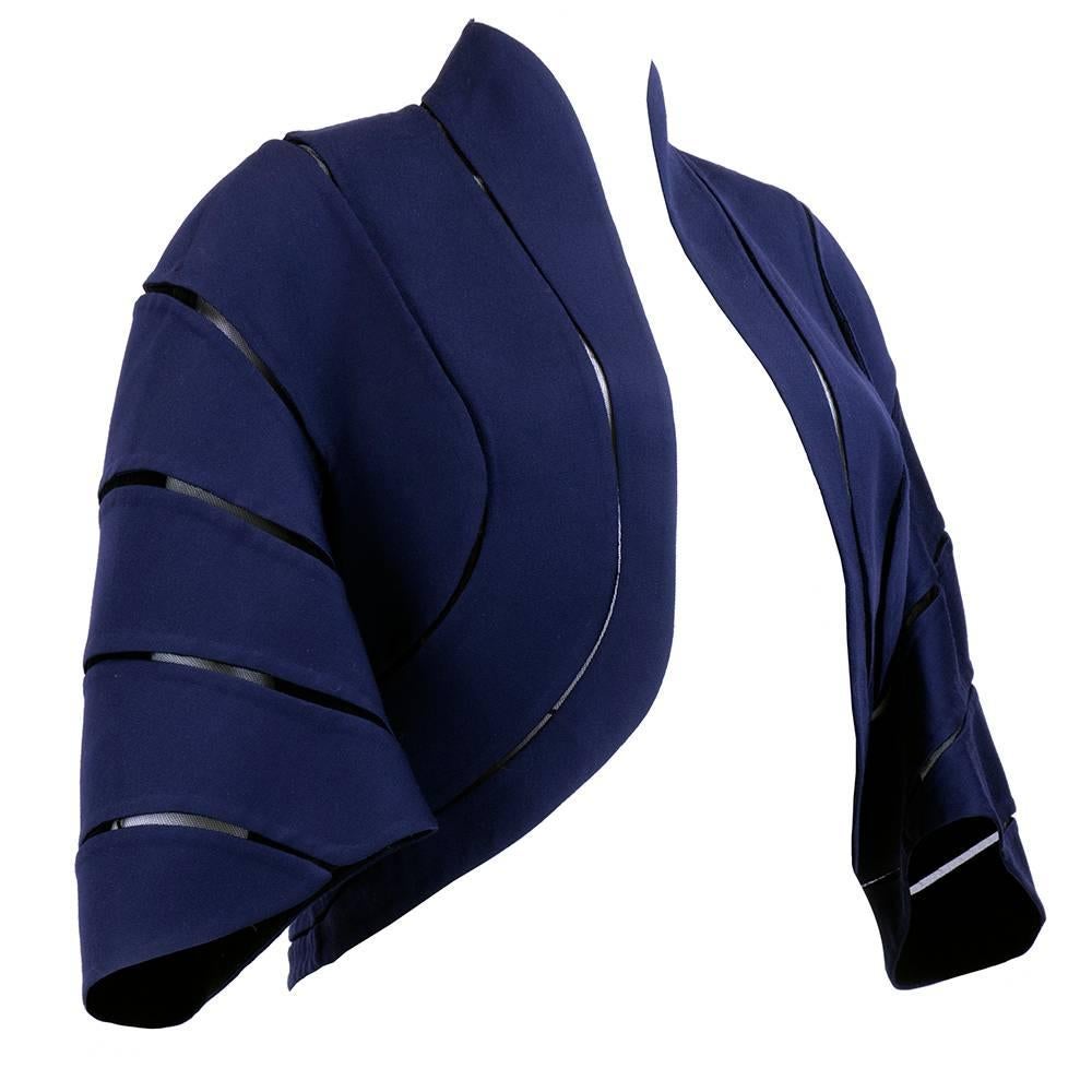 Beautifully constructed double faced fine wool jacket. Blue panels interspersed with net. Open front with dropped shoulders and three quarter sleeves. Fluid lines and fine seams.