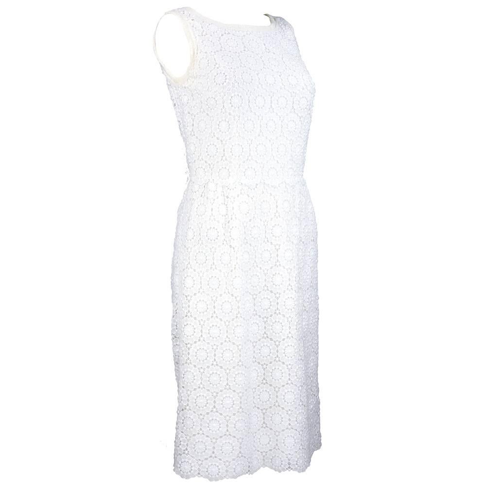 Perfect for summer - simple sheath in white cotton blend crochet lace by Dolce and Gabbana circa early 2000s.  Fully lined. Edged in delicate tulle. A great forever look.