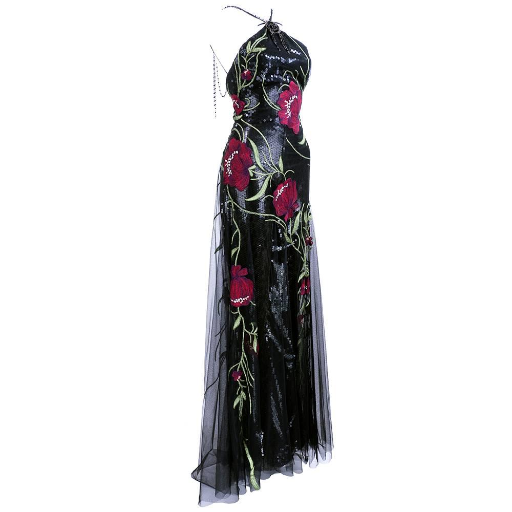 Extravagant evening look by Elie Saab Haute Couture. From recent years - fully sequined jumpsuit with tulle overlay. Racer neck with oversized floral embroidery in deep reds and greens.  Sexy chain link with jet beads on draped halter back. Dramatic