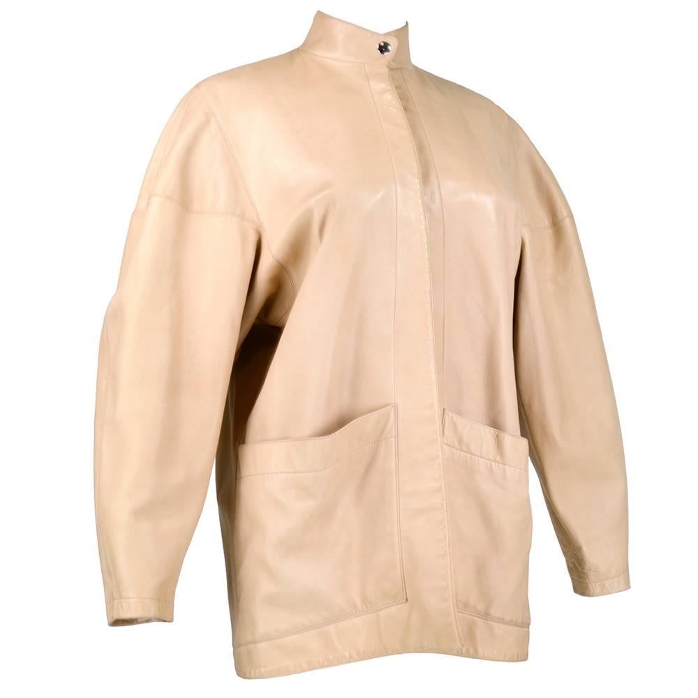 Atypical example from the king of body con fashion. Nude, butter soft leather jacket with single snap closure at neck. Oversized, open front  - fully lined with patch pockets at hip.  Simple yet elegant.