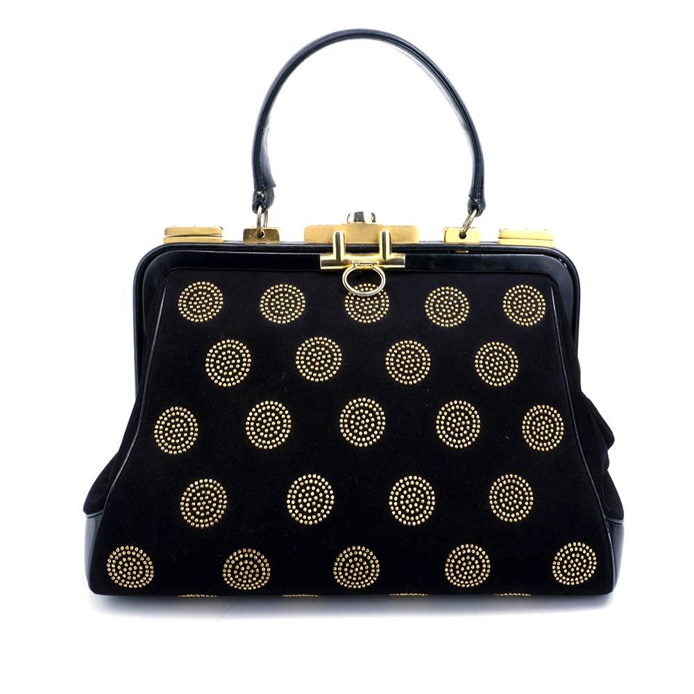 Classic structured handbag by iconic designer Judith Leiber. Black super soft leather and suede  circles of gold tone studs. Great gold tone hardware. A lifetime statement piece. Comes with matching coin purse and faux tortoise shell comb.