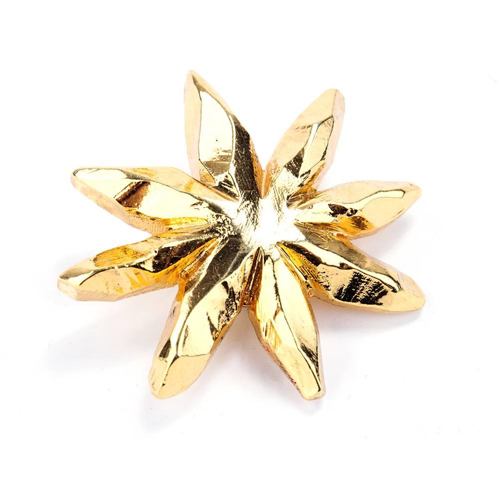 Great 90s era gold tone ear clips in abstract starburst pattern by Christian Lacroix . So dramatic. Power look.