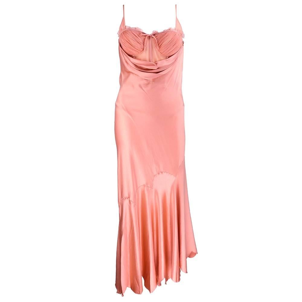 From the late, great Alexander McQueen circa 1990s. Peachy pink satin bias cut gown with attached bodysuit. Beautifully draped and trimmed in delicate tulle. Boned bodice with built in bra.  Petalled seams and hem - a design marvel. 100% silk.