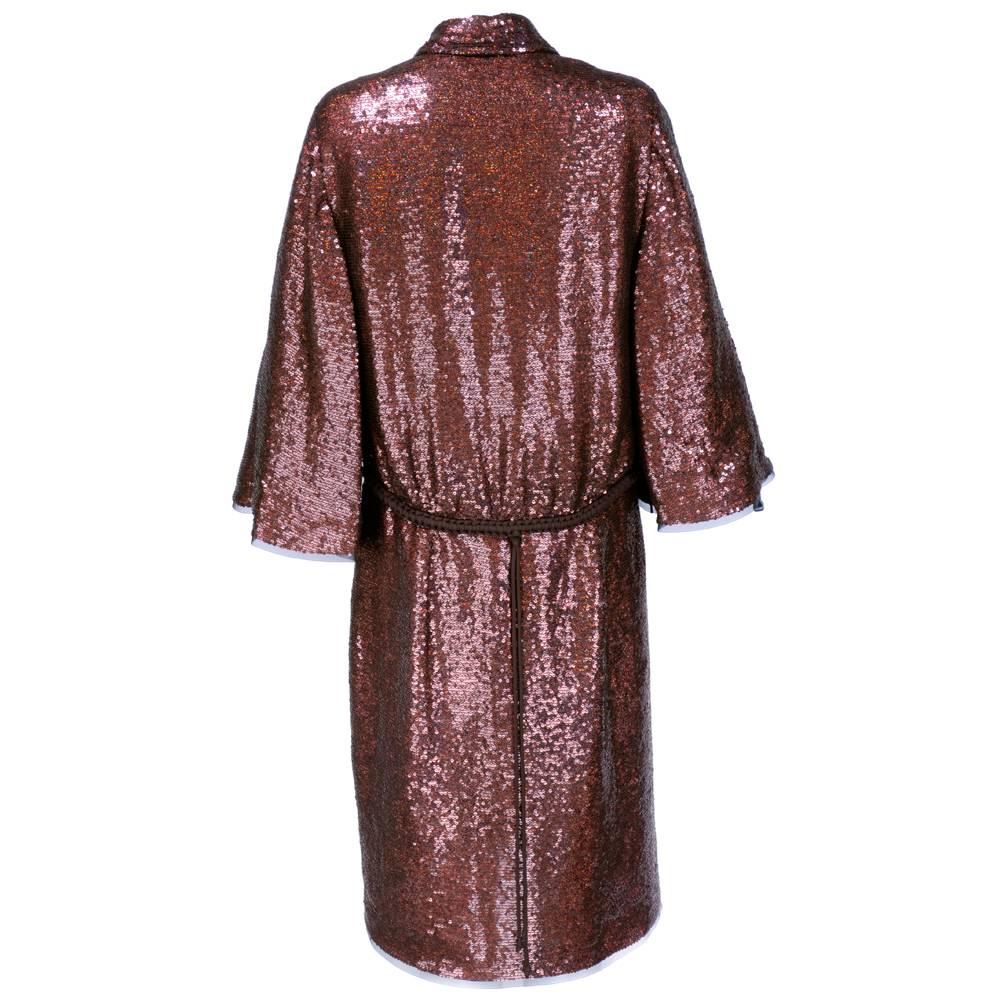 Simple and elegant couture evening coat by iconic designer Ralph Rucci for his Chado Ralph Rucci label. Fully covered in iridescent rootbeer sequins. Semi-gathered in back with a flat front that has an attached braided belt and inner petersham.