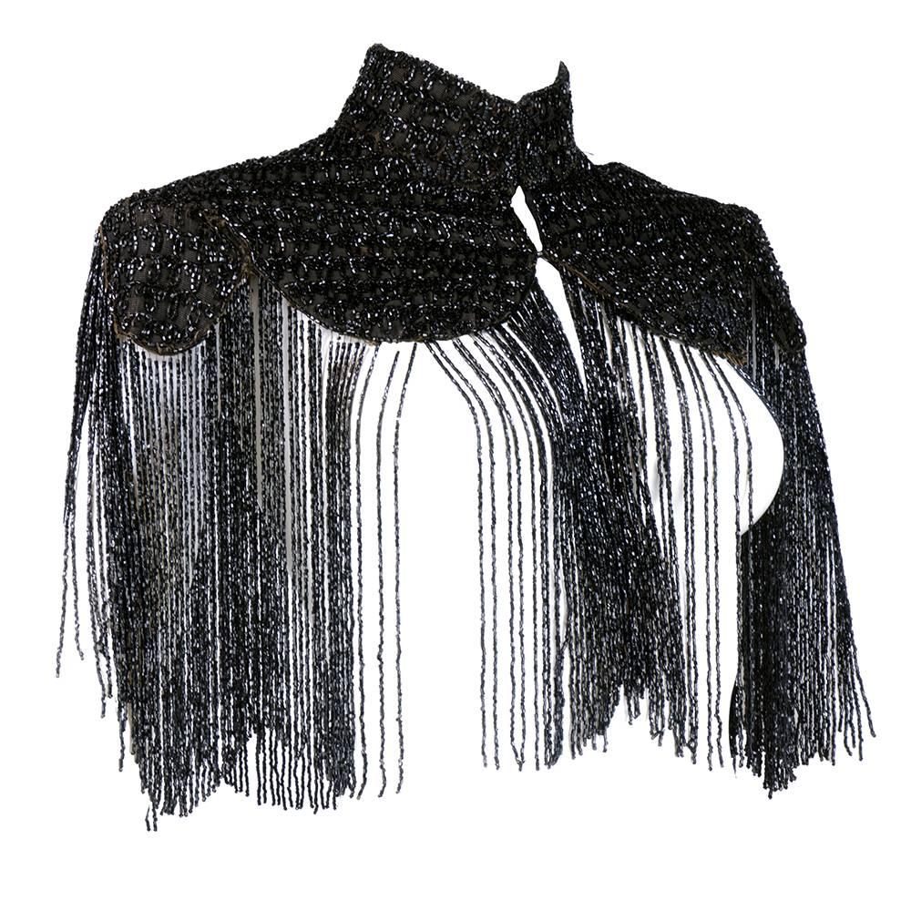Wonderful gothic style Victorian piece. High neck capelet heavily embellished with jet beads. Long beaded fringe - a few strands missing - does not detract from overall look.  Fully lined with  hook and eye closures at neck. A highly dramatic