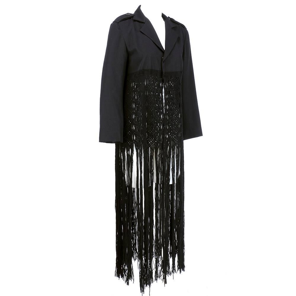   Circa 1990s Yohji Yamamoto blazer cut jacket on top - cropped to extra long macrame fringe. Quintessential business up top - party down below. Unlined body (sleeves are lined) with epaulets. Double oversized snap closure. Wool gabardine. Unlabeled