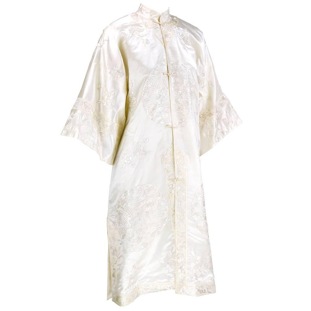 Rare all white silk Chinese robe with all white embroidery in classic Chinese style . floral and dragon motif.  Fully lined in jacquard with frog closures.  Great casual or dressy. Slight nicks and slubs not noticeable when worn.