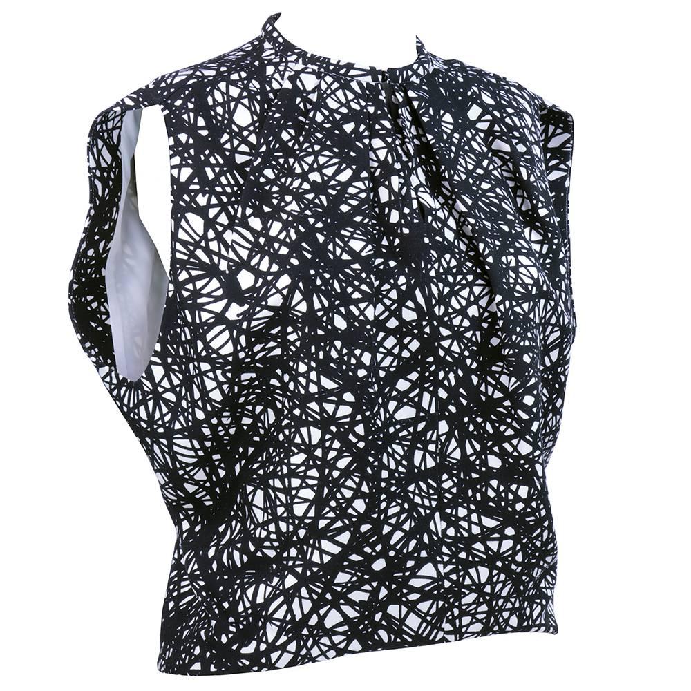 100% silk black and white sack cut blouse in the classic cut and style of Balenciaga. A great updated classic. Can go from red carpet to a picnic lunch!