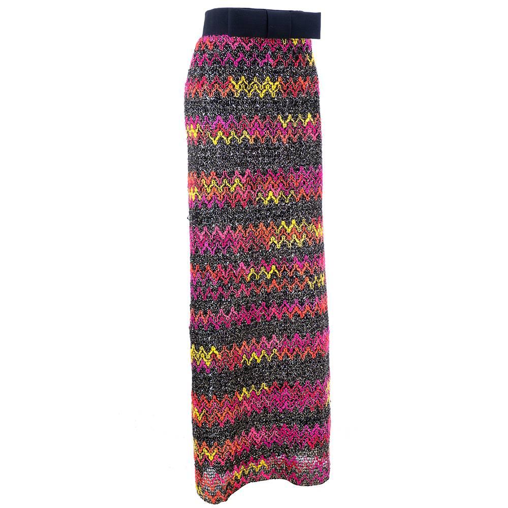 1960s super mod moment. Full length rainbow zig zag knit with metallic and cellophane strips. Wide black waistband with oversized bow. Fully lined.