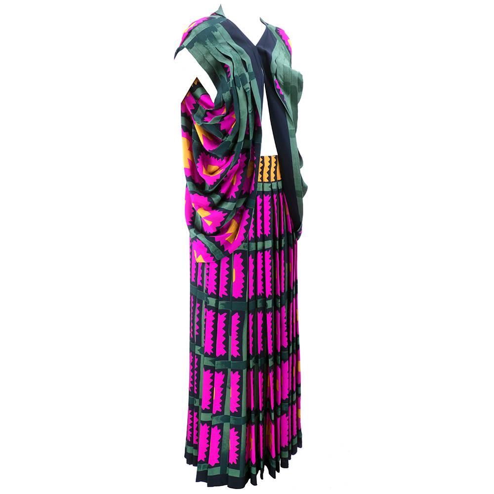 Wonderfully, boldly bright graphic print open front jacket and long pleated skirt by artist Michaele Vollbrach. Shades of magenta, mustard, green and black.  Jacket is split up the back with pleated sleeves with dropped armholes. Full length pleated