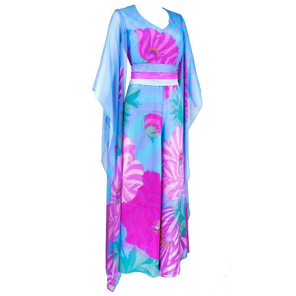 Iconic Hanae Mori large scale dramatic floral motif on statement making jumpsuit.  Signature Pink and blue color scheme.  Dropped kimono-esque sleeves with wide legs. Wide obi-like belt goes over fitted waist and zips up back. 100% silk with rayon