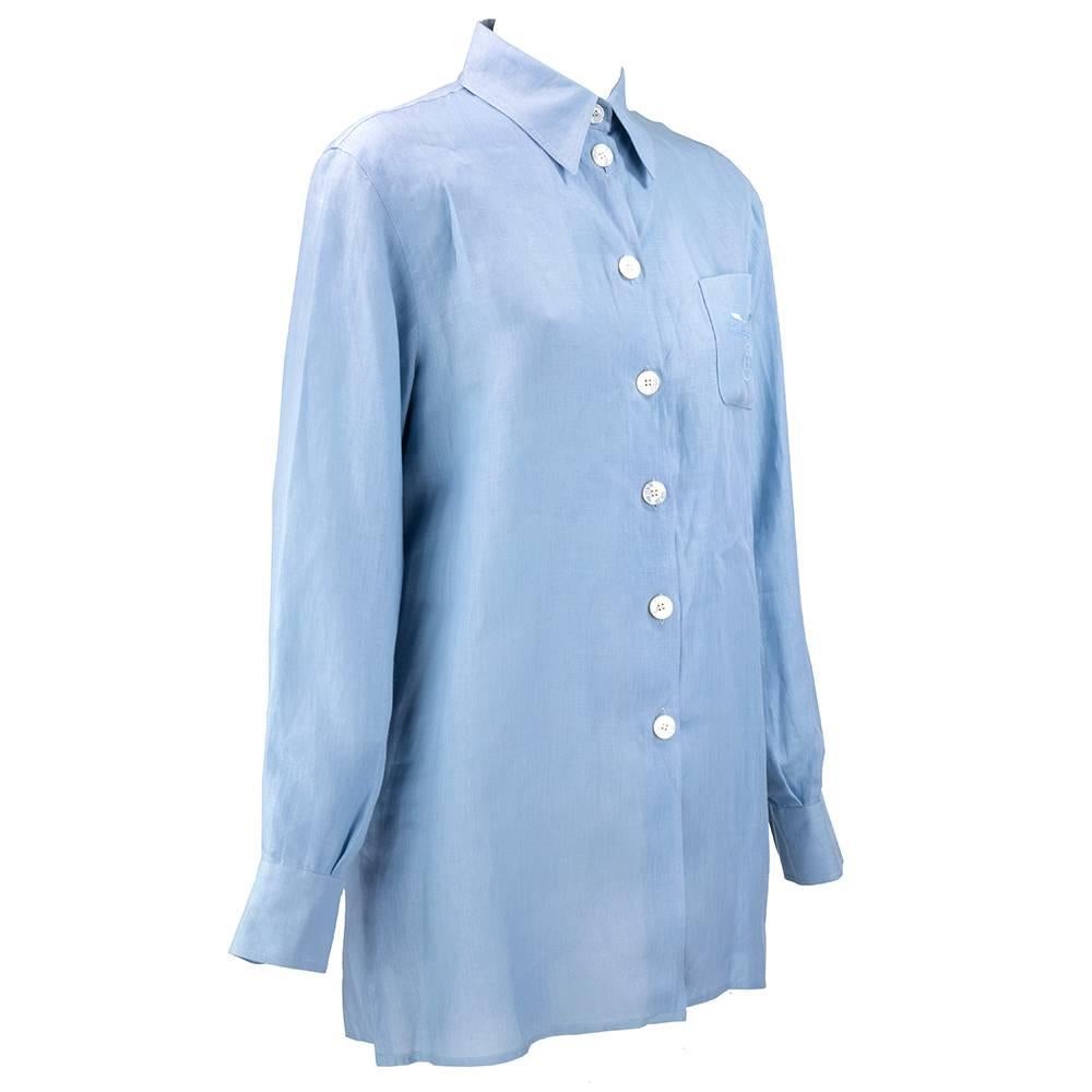 Simple and classic menswear button down shirt with oversized mother of pearl buttons. Circa 1990s - possibly from the Margiela years? Palest of baby blues, softest of linens. A wonderful lifetime piece with overstated embroidered logo on pocket.
