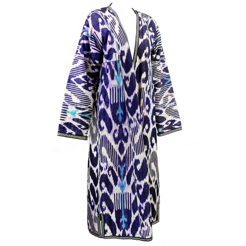 Visually stunning full length robe in hues of purple, blue and white. Lining edged in vibrant stripes with quilted homespun cotton floral. From Uzbekistan.