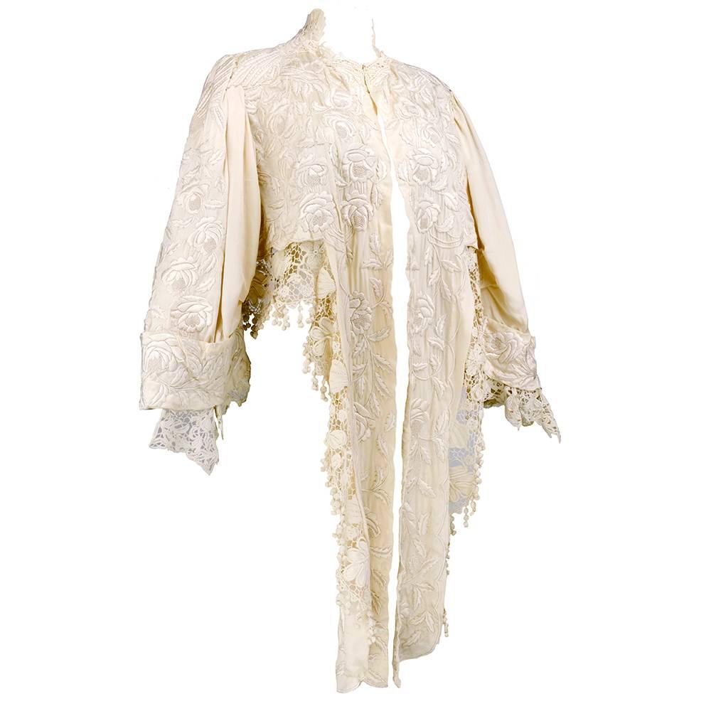 Gorgeous and elaborate Victorian era or wrap. Lush ivory colored silk trimmed in ornate crochet. Heavily embroidered in floral motif. Unlined with hook and eye at neck.Wonderful bridal piece.