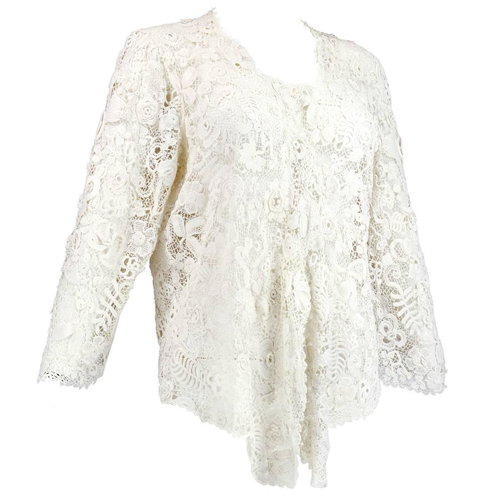 Super stunner. Pure white short cotton jacket that dips at front with flared sleeves. Stunning workmanship. Open in the front. 