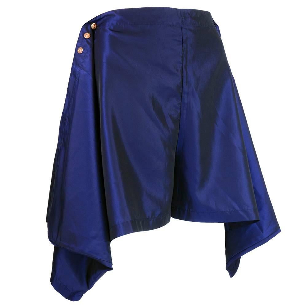 Typically atypical design from JPG. Deep iridescent blue taffeta shorts with adjustable snap closure at both sides of waist. Swags of fabric cascade down both sides. High waisted to wide leg opening - bermuda length. Almost skort-ish  but