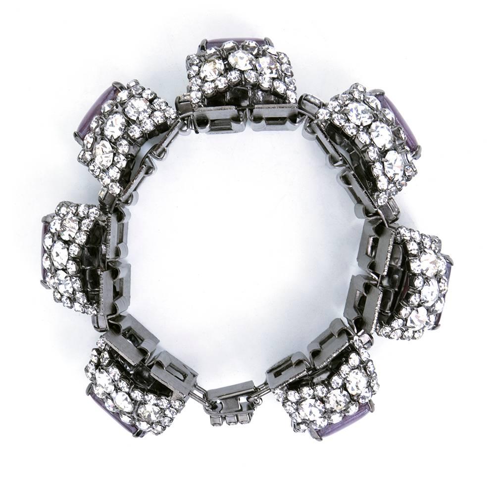Super festive, high glam bracelet with linked panels of oversized rhinestones with centers of faux amethysts. For crazy nights and wild days. A true showstopper. Wear this piece and win at being the sparkly-est wherever you go!