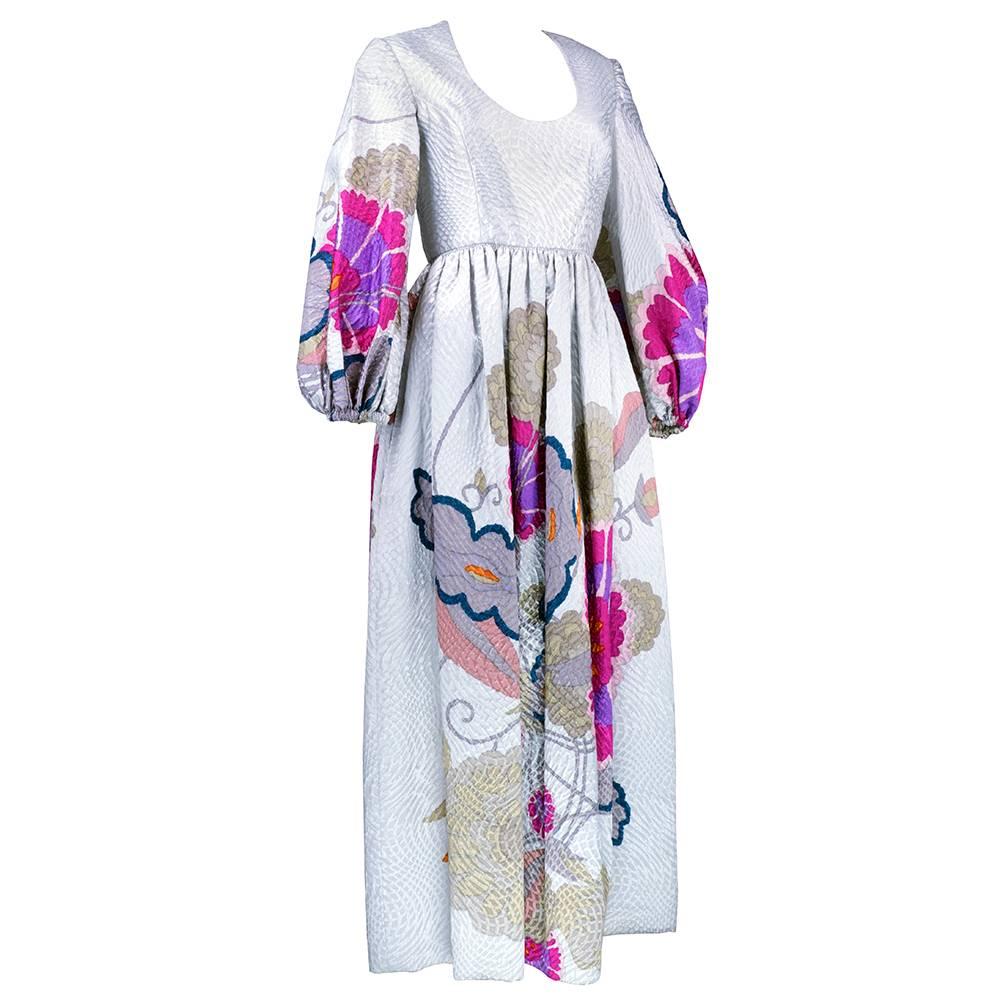Serious 1960s moment in silver metallic matelasse. Scoop neck, snug waist and full, gathered sleeves. Asian inspired large scale floral print. Fully lined. 