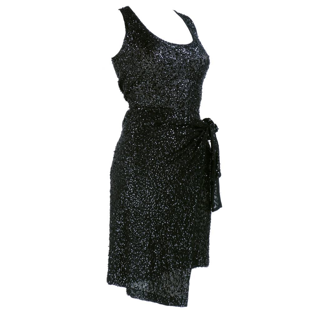 Power dressing by Donna Karan circa 1990s. Ensemble made up of rayon blend stretchy knit with signature bodysuit and matching skirt. Bodysuit pulls over head and  snaps at crotch and skirt wraps sarong style with ties to knot at waist. So versatile