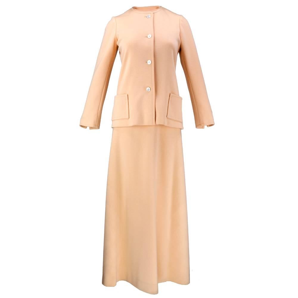 An American classic - Halston's 1970s era peachy woolen evening gown with racer neckline with matching jacket. Easy breezy dressing - maximum chic and maximum comfort. 

Jacket-
Bust: 34 inches
Length: 24 inches