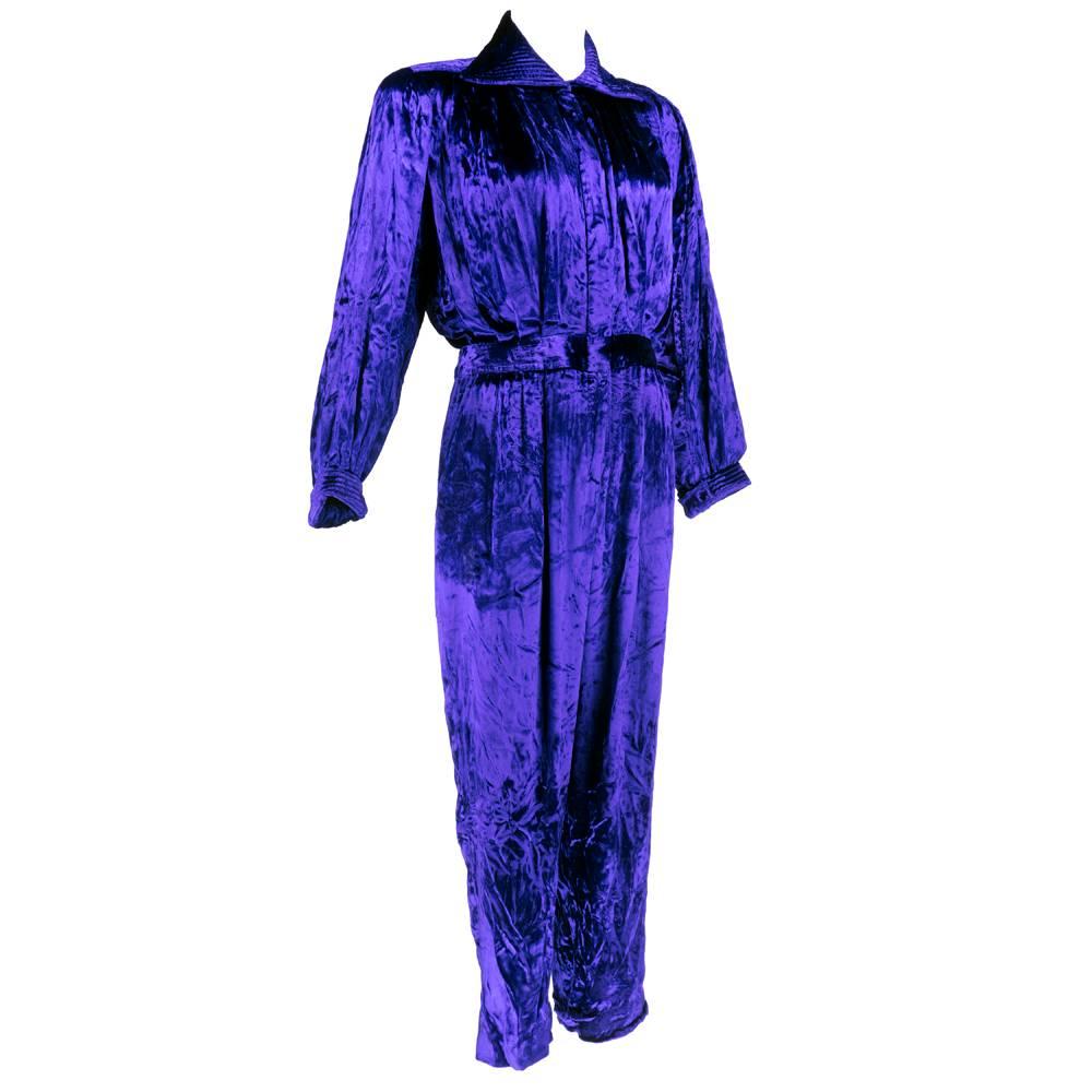 The very best jumpsuit in the world. Unlabeled Yves Saint Laurent purple velvet with high sheen. Draped beautifully with padded shoulders, fitted waist, full legs with narrowed cuff. Banded waist with pleated, hidden pockets. Quilted, peaked collar