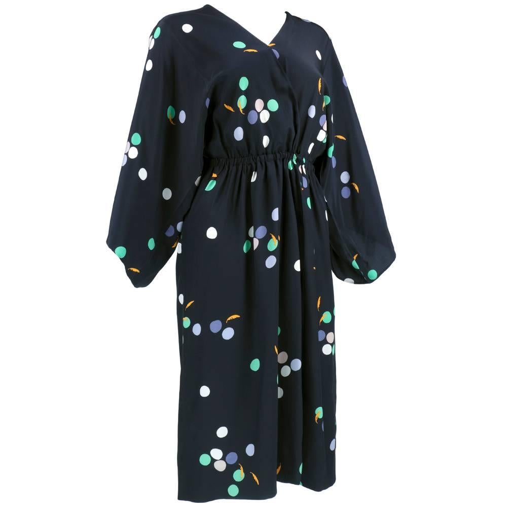 Ultra chic and easy to wear - a true classic. Halston circa 1970s silky wrap dress   with abstract scattered polka spot print.  Elasticized waist for stay put fit. Kimono style with wide sleeve .