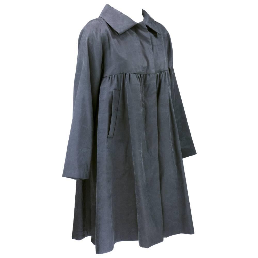 Interestingly textured 100% silk coat by design genius Dries Van Noten. Washed grey black washed out color. Babydoll-esque cut with oversized collar. Unlined with slash pockets.