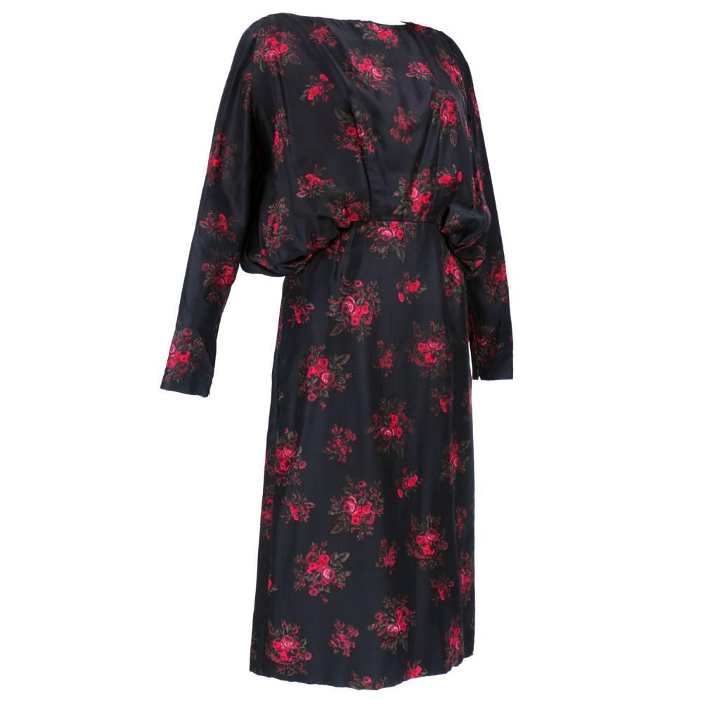 Super chic dressy dress by Parisian/American designer Pauline Trigere. Silk, floral print with blousoned overblouse. Long sleeve with zipped cuff. Fully lined. Incredible drapes at waist and on back.