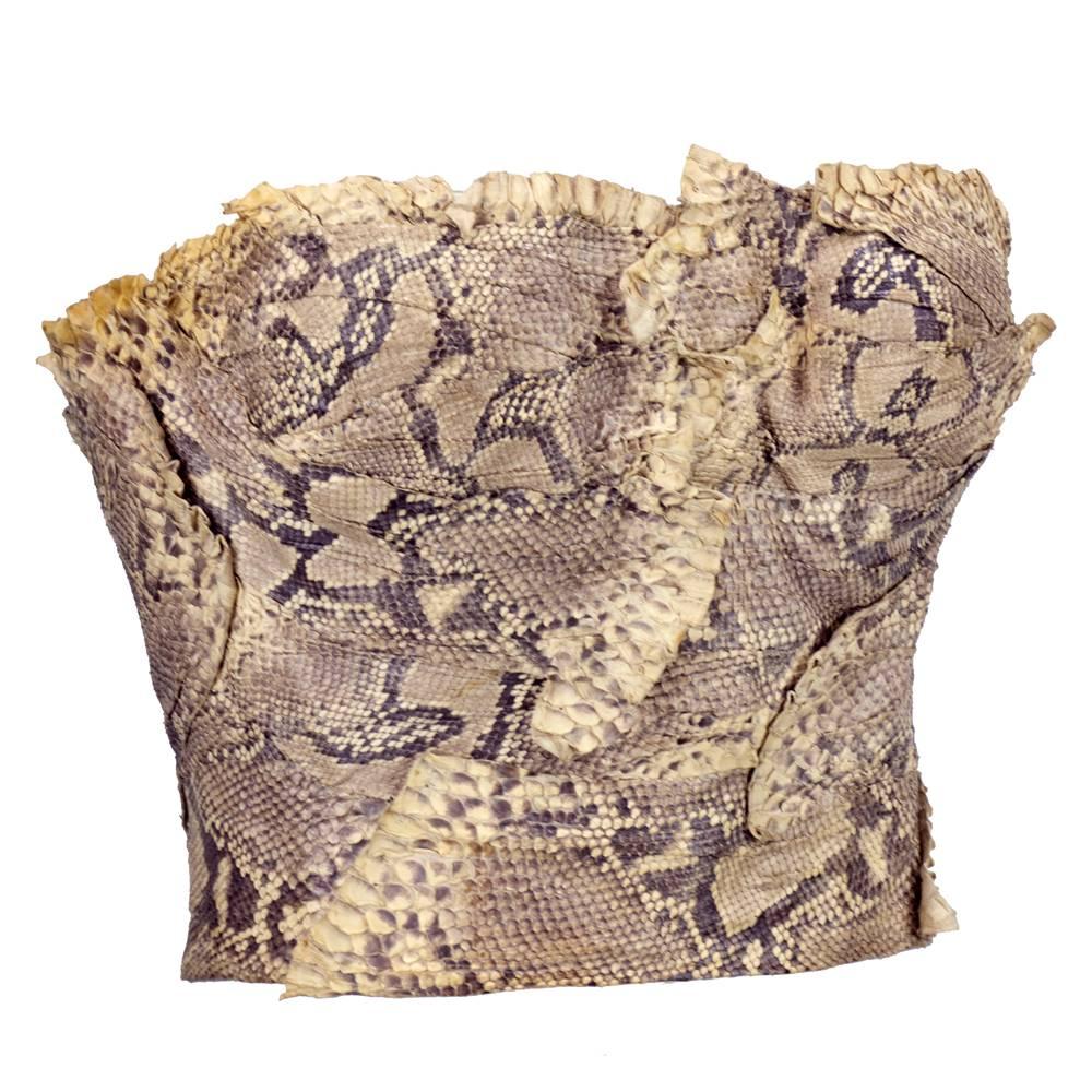This fabulous bustier from John Galliano is made from luxe snakeskin in natural brown tones that is intricately pleated and formed to fit the body. The snakeskin even appears to ruffle along the hem! Fastens in the back with hook and eye closure.