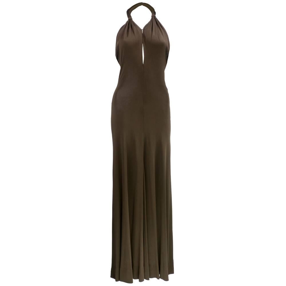 An incredibly sexy halter gown from the master of slinky jersey, Halston. The gown has a knotted halter collar and subtle deep neckline; it is also paired with a fabulous ostrich-feather trimmed jersey wrap.

Measurements--
Bust: 36 inches
Waist: up