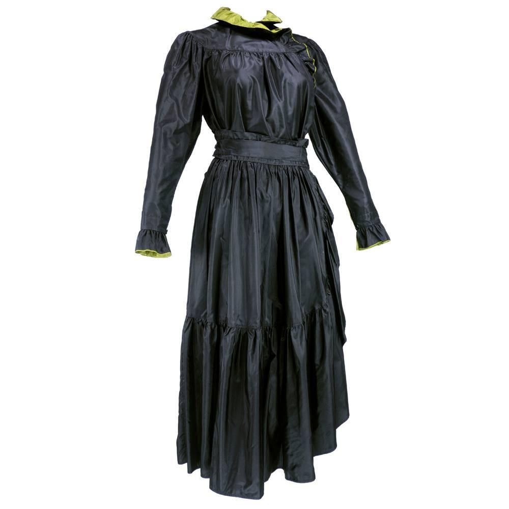 Romantic  two piece ensemble by Japanese designer Kenzo. Circa late 70s to early 80s black silk taffeta peasant style blouse with olive green lining. Matching skirt with wide cascading ruffle. With matching sash.

Blouse
Bust:  42