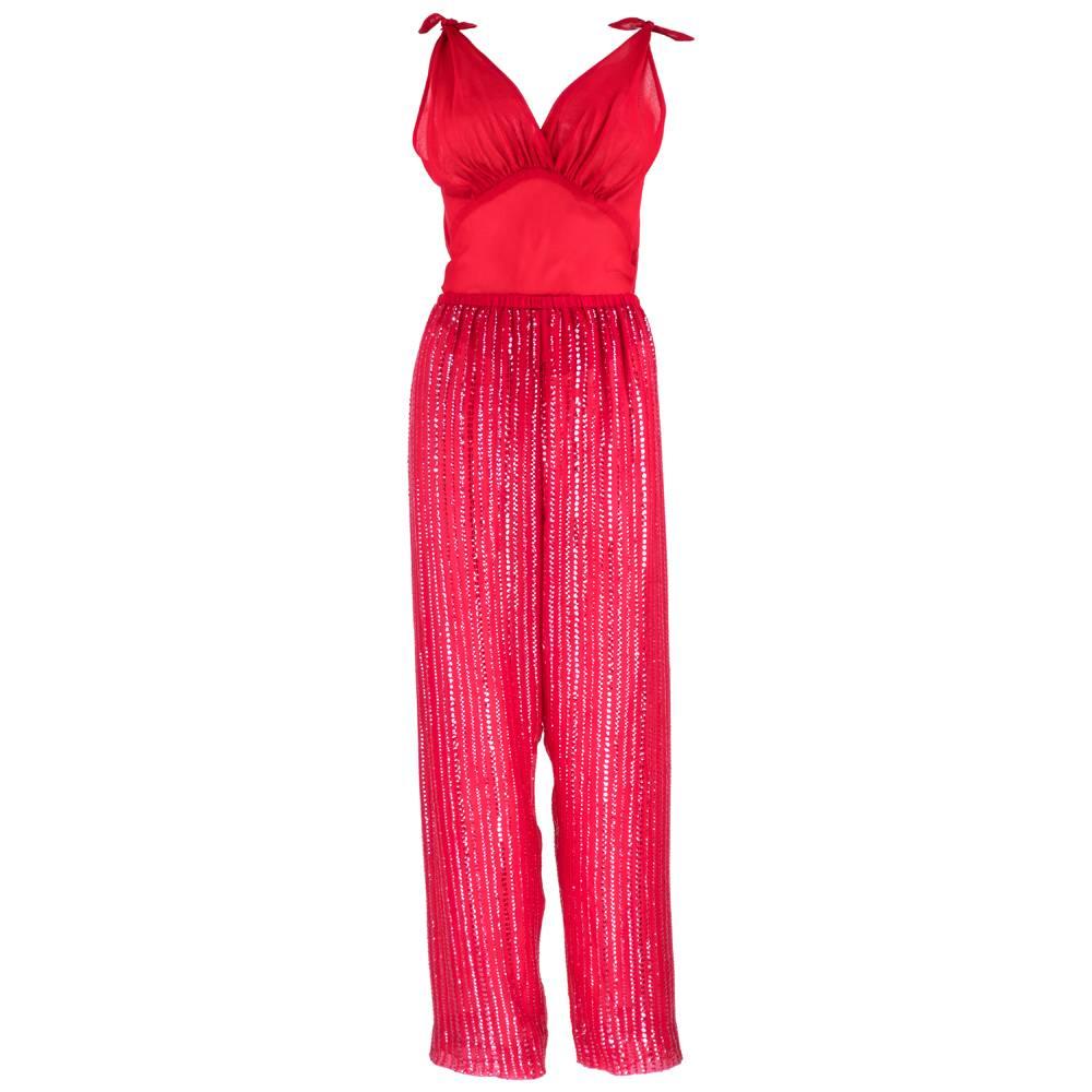 Fabulous three piece candy-apple red silk georgette ensemble from Halston features trousers, sleeveless blouse and jacket. Kimono sleeved jacket is embellished with rows of iridescent sequins, fastening with a single hook and eye at the neck.