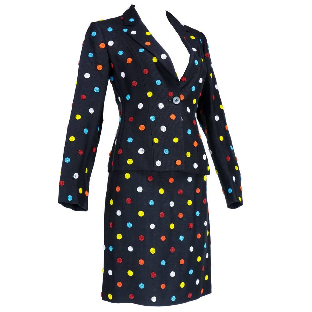 Signature whimsical styling by Moschino circa 1990s for his Cheap and Chic line. Black with rainbow polka dots that are fully beaded. Fully lined with single button closure.

Skirt-
Waist: 24"
Length: 21"