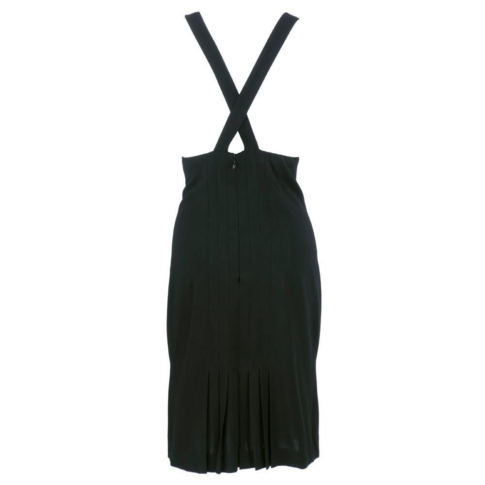 Circa early 2000s little black dress by Chanel.  Low cut, cowled neckline with criss cross halter back. Incredible wool spandex blend fabric. Fitted pleated skirt with fluted hem. Super sexy on.