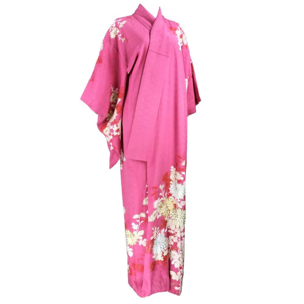 stunning kimono in rose pink jacquard with scattered floral print accented with multi-color metallic embroidery.  print also edged in gold foil. Long drop sleeves. Lined in white.