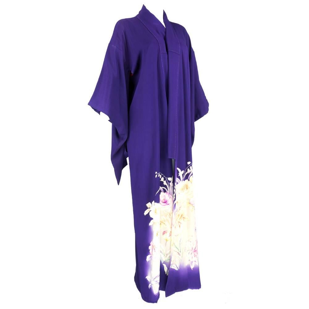 Simple yet stunning Japanese kimono in purple silk with floral print around lower half. Light embroidery enhances print. Beautiful workmanship. Lined in vibrant red.