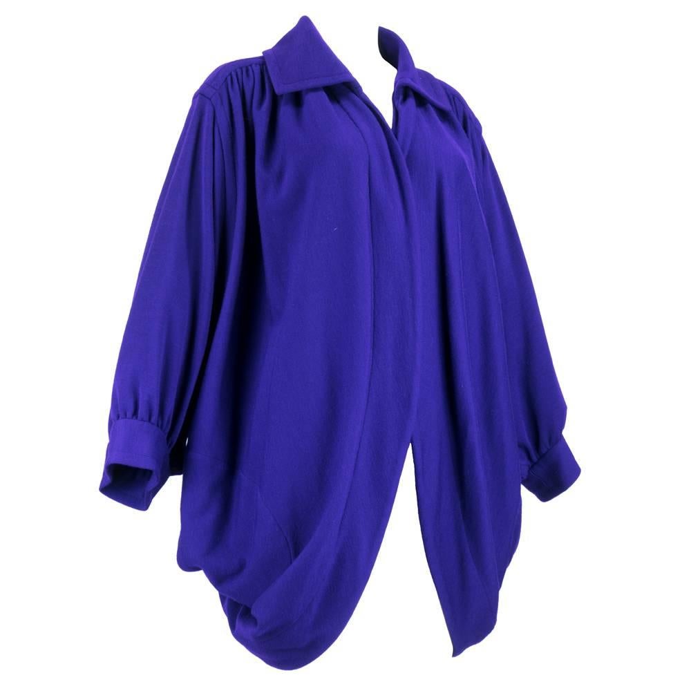 Vibrant gem colored purple oversized jacket in lightweight wool by Saint Laurent for his Rive Gauche line. Cocoon style with overaized collar, dolman sleeves with large patch pockets. Chic and practical. One size fits most. One tiny pinhole on