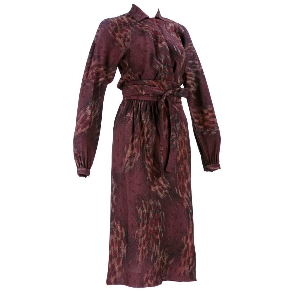 Classic Halston circa 1970s Wrap style dress in lightweight wool blend. Semi elasticized waist with self tie belt. In warm browns, burgundy and rust. Perfect dress for Fall/