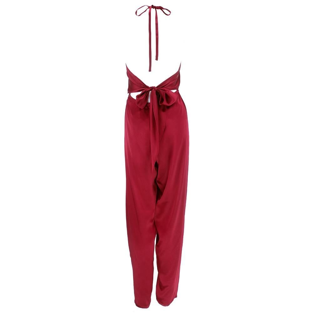 10 out of 10 for a jumpsuit. Slinky, sexy silk charmeuse in a lovely burgundy. Perfectly cut and draped by the masterful and beloved designer Stephen Burrows circa 1970s. Disco ready. Lightweight with beautiful movement - has self wrapping tie at