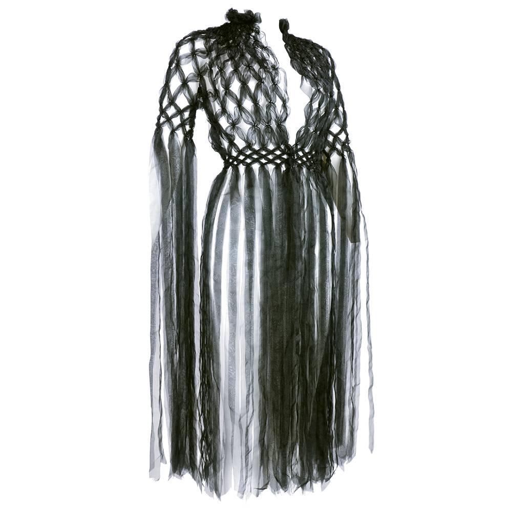 Intricately woven and constructed by the protege of Comme Des Garcons Rei Kawakubo. Black interwoven silken strips ending in long, flowing fringe. Single button closure. a masterwork by a legend in the making.