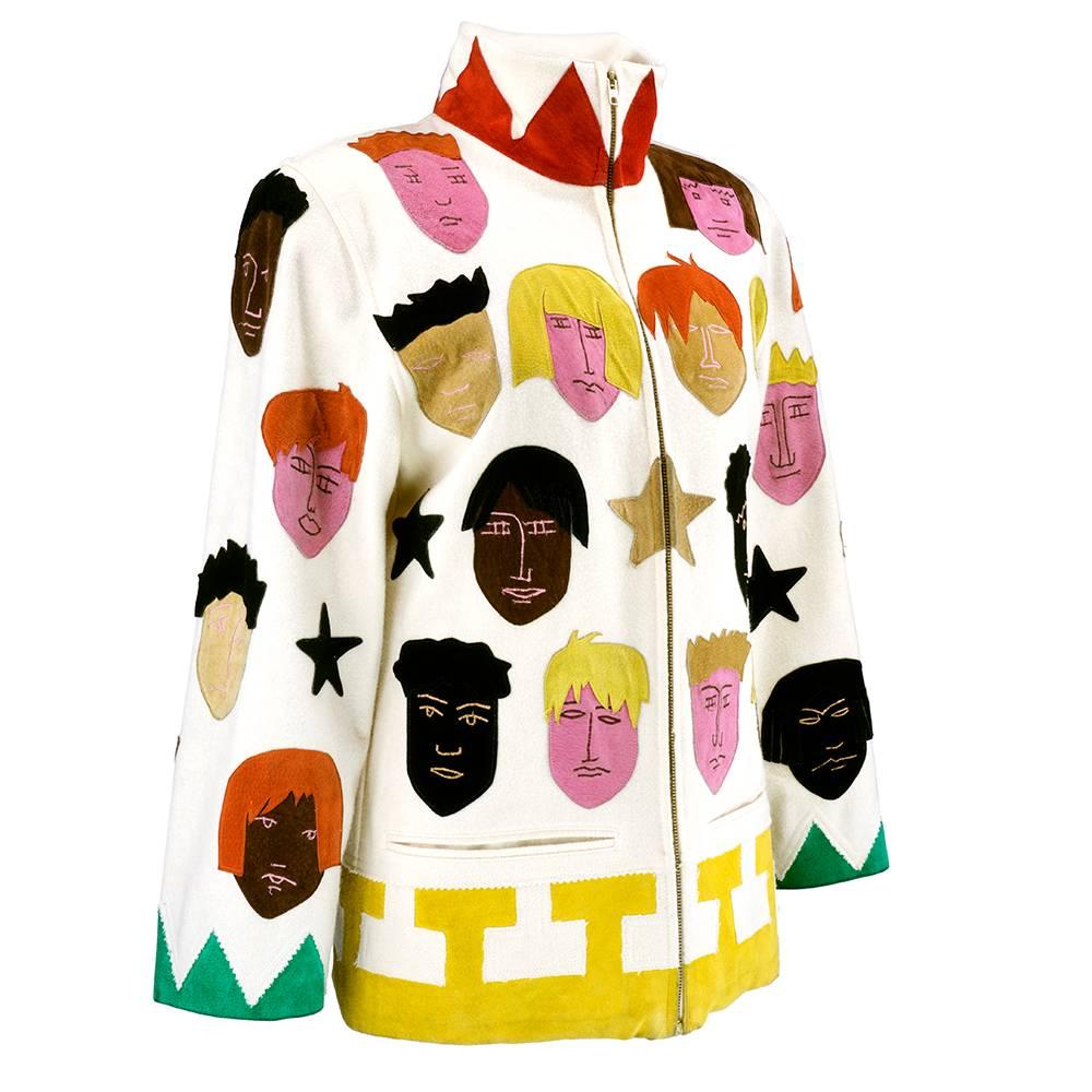 Art to wear from the artist/designer Jean Charles de Castelbajac. Signature humorous and ingenious styling and construction. Ivory woolen car coat style with stand up collar and slightly padded shoulder. Zip front with low slash pockets. Appliquéd