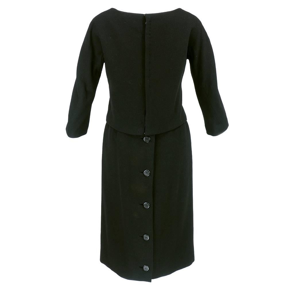Classic Christian Dior afternoon dress circa early 1960s. Under dress has slip top with hook and eye closure with slight discoloration under arms with button front straight skirt. Over blouse is cropped and fitted with three quarter sleeves and