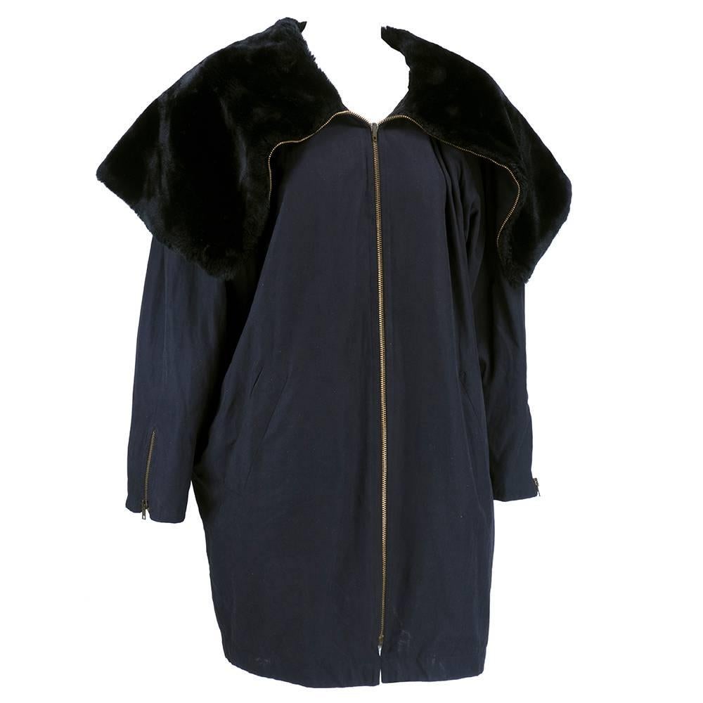 Lightweight and cozy zip front jacket by Byblos circa 1990s. Acrylic-polyester blend with quilted lining and oversized faux fur collar that zips up into giant cowled collar. Zips at cuff with slash pockets. 
