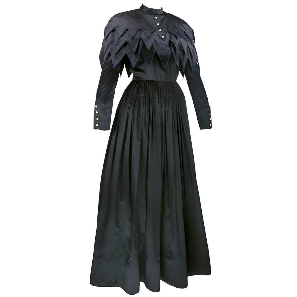 Chanel goes a bit goth with this fabulous black ball gown. Inspired by Edwardian silhouettes, this gown is given a modern, updated feel with the tiered geometric bodice. The high neck and long sleeves are offset by the whimsical design and detail.