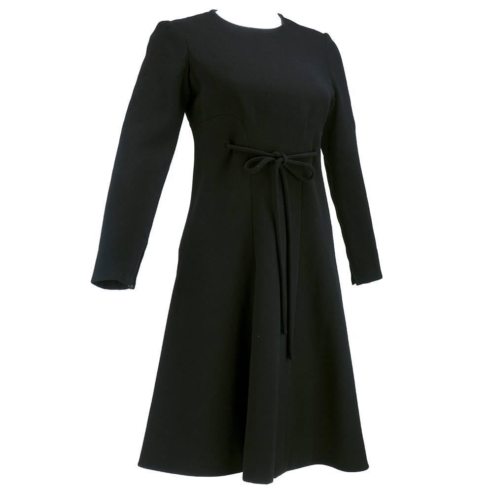 Little black haute couture dress by the house of Christian Dior from Autumn/Fall 1971.  Black 100% wool slightly A line dress. Self belt ties at waist.  Partially lined. From the era of Marc Bohan. Please contact for more detailed images of this