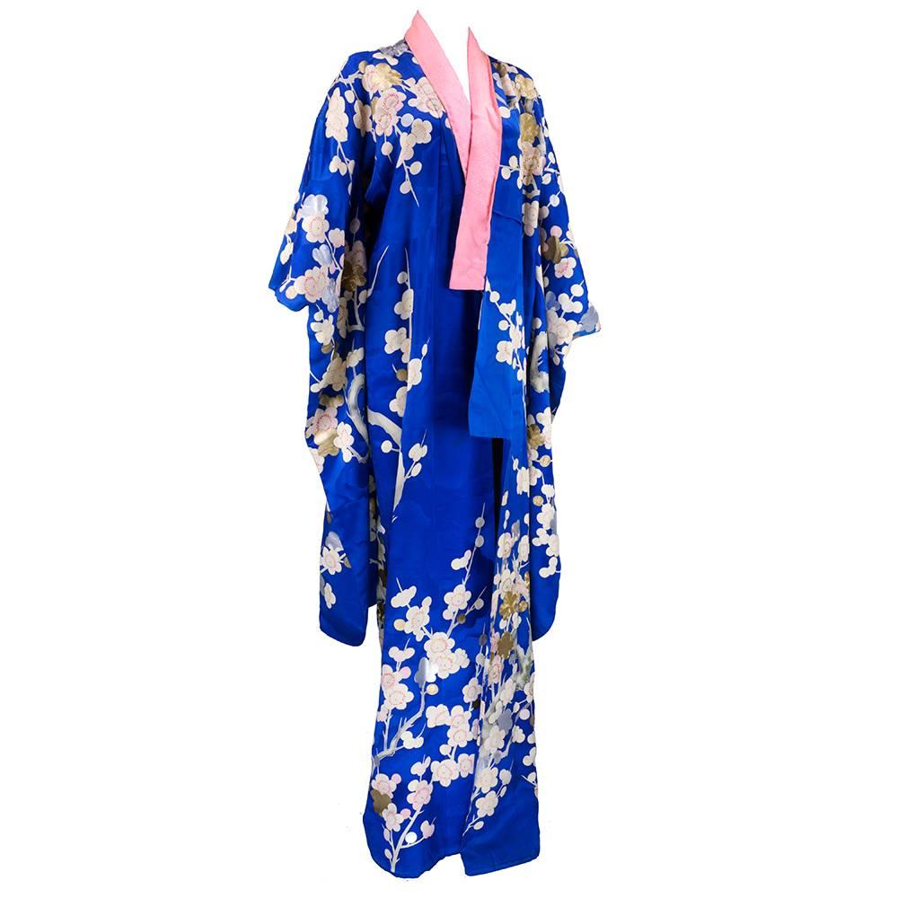Amazing kimono in a vibrant blue with cloud jacquard pattern. Floral print with hand painted accents and metallic embroidery.  Extra long dropped sleeve. A true work of art. Some discoloration on lining - not noticeable when worn. Very slight