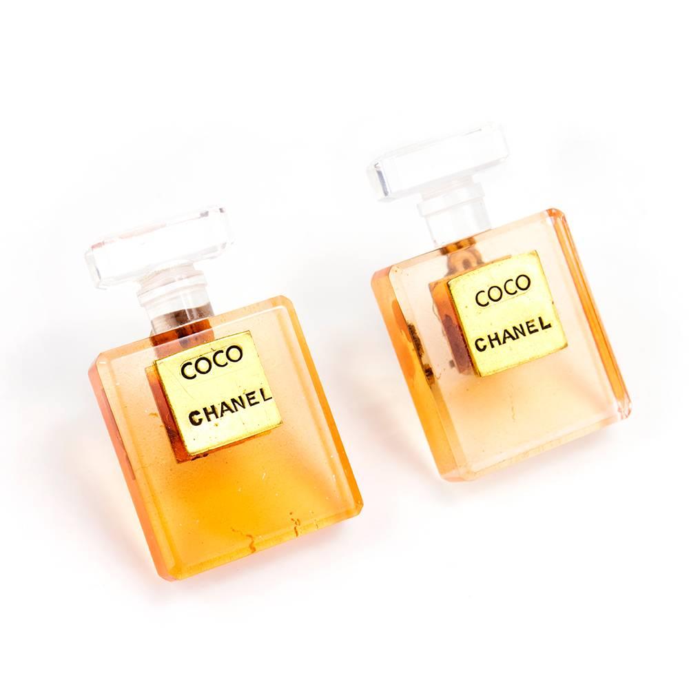 1990s classic Chanel earrings. Coco Chanel perfume bottle earrings in lucite with goldtone hardware. Clip on style. Comes with original box.
