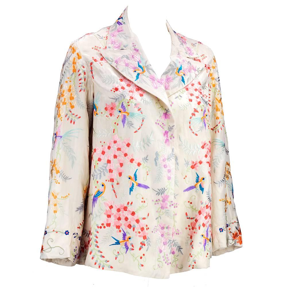 1920s era Chinese silk jacket. Ivory silk with floral and bird motif embroidery in delicate pastel shades. Fully lined with open front and fold over collar. Great for casual or dressy wear. Very slight discoloration - does not detract from overall